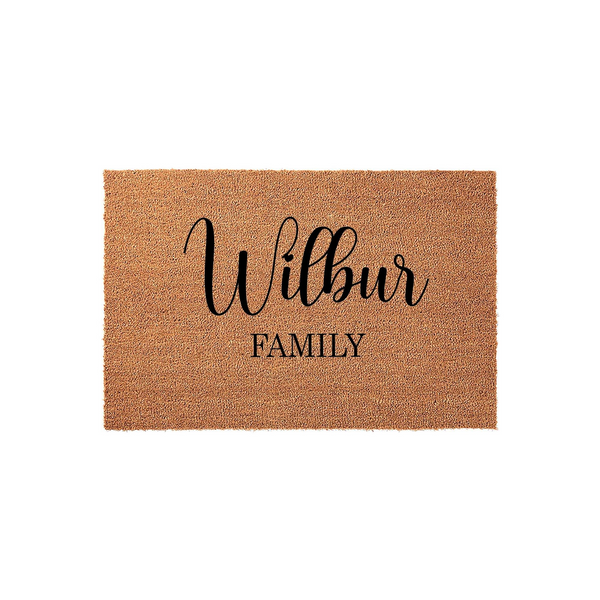 Personalized family name coir doormat featuring a natural brown fiber texture with elegant black script lettering that displays a custom last name, making it a welcoming addition to any front porch or entryway decor for your home.