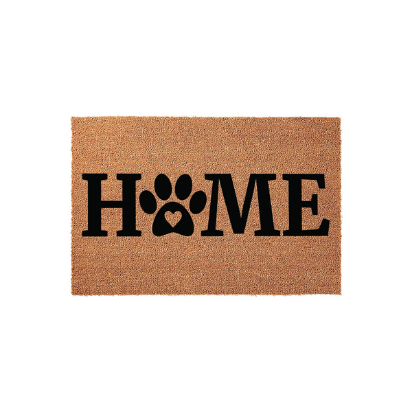 Home paw print coir doormat featuring a natural tan fiber texture and bold black lettering where the letter O is replaced by a cute dog paw print with a small heart cutout in the center, set against a clean white studio