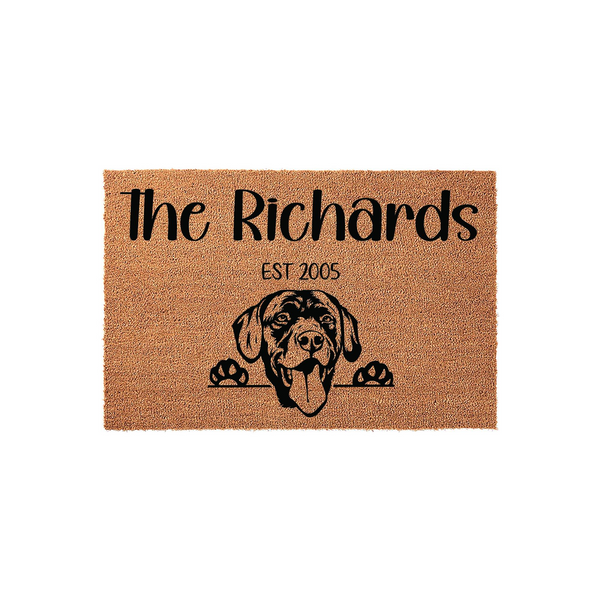 Personalized Labrador Retriever doormat featuring a natural coir texture with a black printed illustration of a happy dog peeking over the edge, customized with a family name and established year on a clean white studio