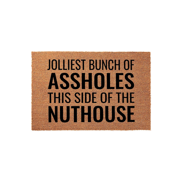 Funny Holiday Doormat featuring the text Jolliest Bunch of Assholes This Side of the Nuthouse printed in bold black lettering on a natural brown coir fiber mat, perfect for adding a humorous touch to your front porch decor this