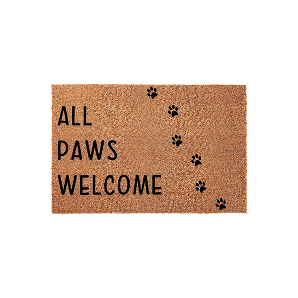 All Paws Welcome coir doormat featuring a natural tan fiber texture and bold black lettering, accented by a playful trail of black paw prints leading across the surface for a charming pet-friendly entrance to your home.