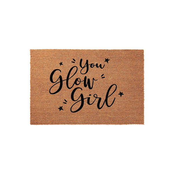 You Glow Girl coir doormat featuring natural brown coconut fiber material with black printed text and small star accents, displayed against a clean white background for a modern and welcoming entryway decor style.