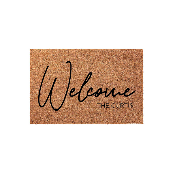 Personalized coir welcome doormat featuring a natural tan fiber texture with the word Welcome written in a large black script font and a custom family name printed in a clean sans-serif typeface on a plain white studio background.