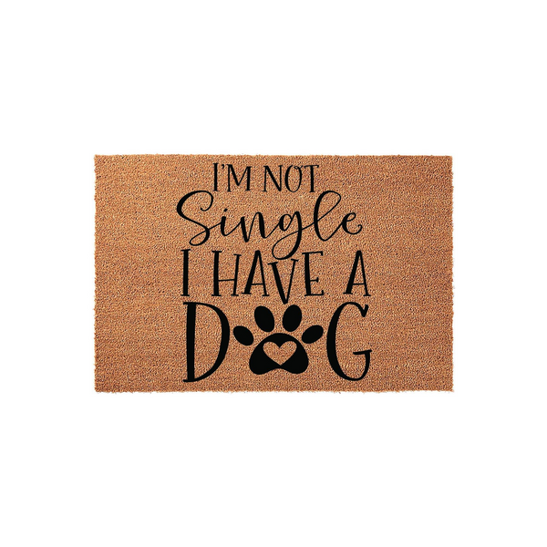 I'm Not Single I Have A Dog coir doormat featuring a humorous message in black lettering with a paw print replacing the letter O, set against a natural tan textured fiber background for a fun and welcoming front porch entryway