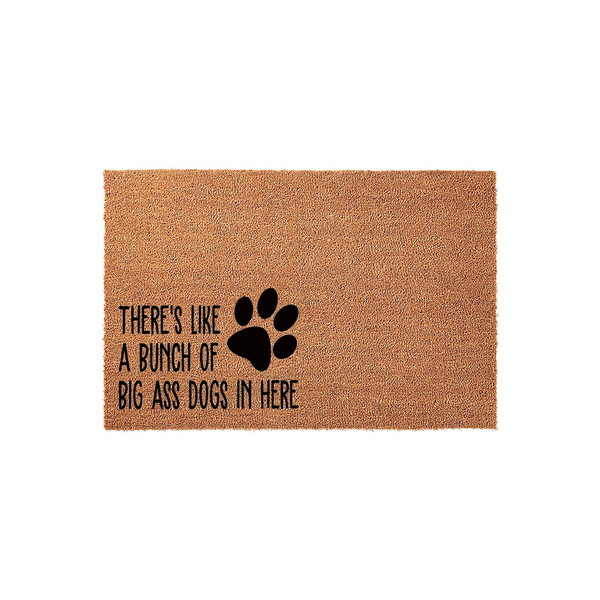 Funny Dog Lover Coir Doormat featuring a black paw print and the text There is like a bunch of big ass dogs in here, displayed on a natural brown textured fiber mat against a clean white background for a humorous home entryway