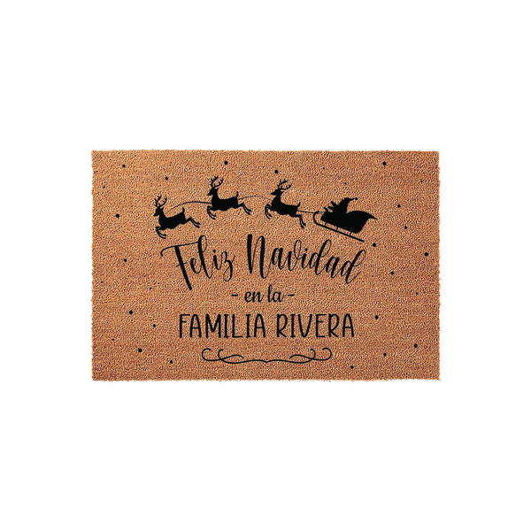 Personalized Feliz Navidad Christmas doormat featuring a black silhouette of Santa and his reindeer flying across a natural coir mat, accented with festive dots and space to add a custom family name for a holiday home entrance.