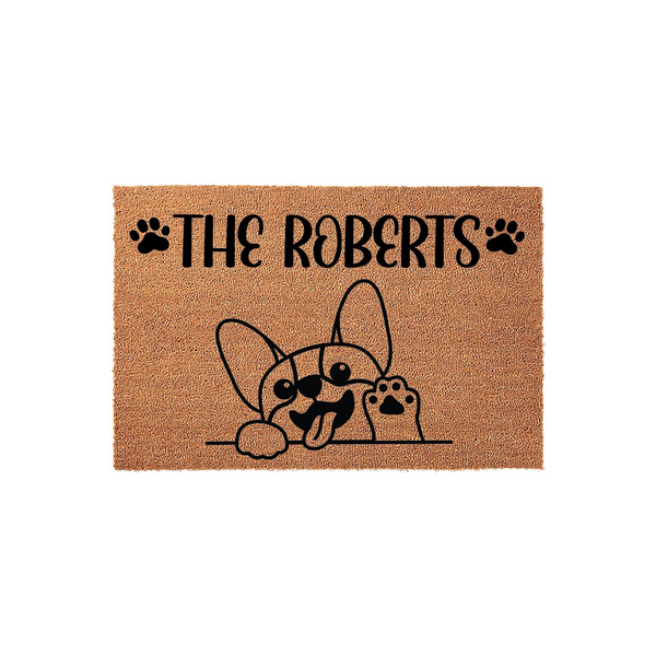 Personalized French Bulldog doormat featuring a cute illustrated dog peeking over a line with its paw raised, customized with a family name in black text on a natural coir fiber background for a welcoming front porch entrance