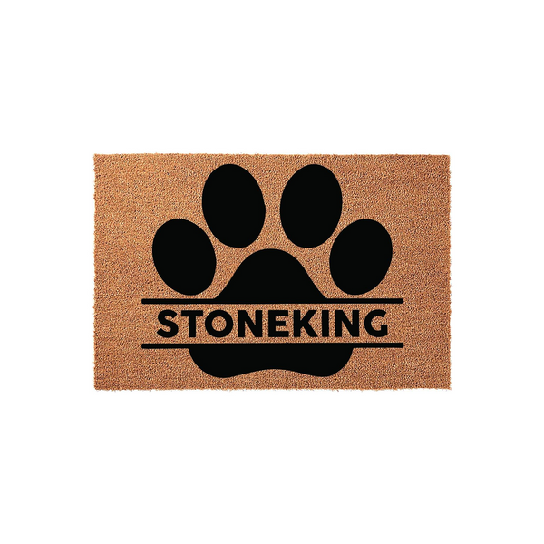 Personalized pet paw print coir doormat featuring a large black paw design with a horizontal split for a custom family name, set against a natural brown textured fiber background for a welcoming and durable entryway floor mat.