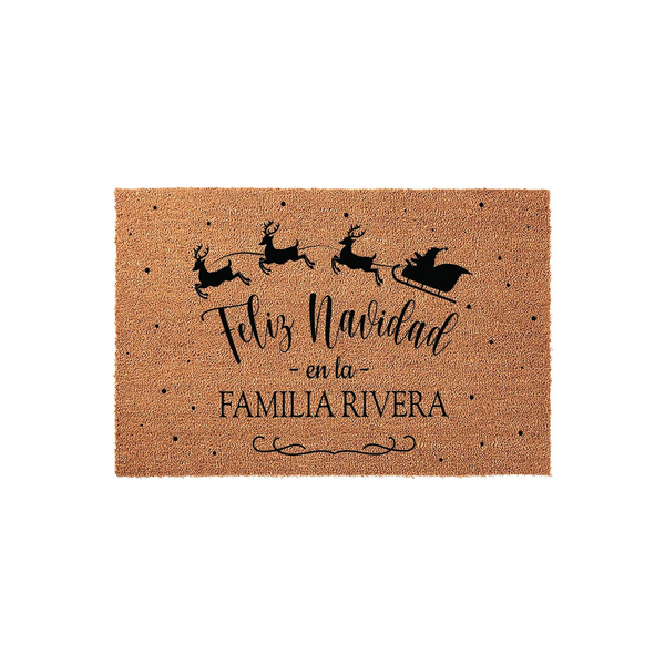 Personalized Feliz Navidad coir doormat featuring a black silhouette of Santa and his reindeer flying across the top, with custom family name text printed in the center against a natural brown textured coconut fiber background.