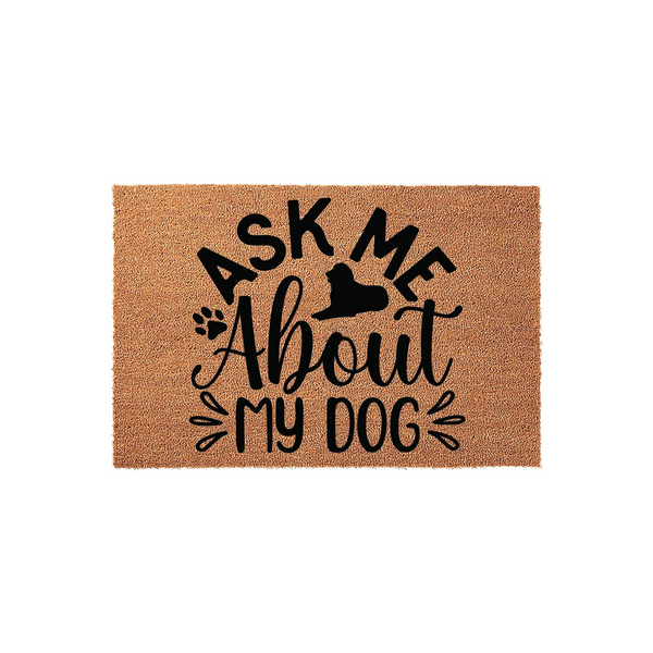Ask Me About My Dog coir doormat featuring a black silhouette of a dog and paw print accents, displayed on a plain white background to highlight the natural fiber texture and the bold, playful typography of this pet lover home