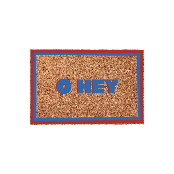 Oh Hey coir doormat featuring a natural brown fiber texture with a bold red and blue border, displaying the playful greeting Oh Hey in matching red and blue block lettering centered on a clean, solid white studio background.