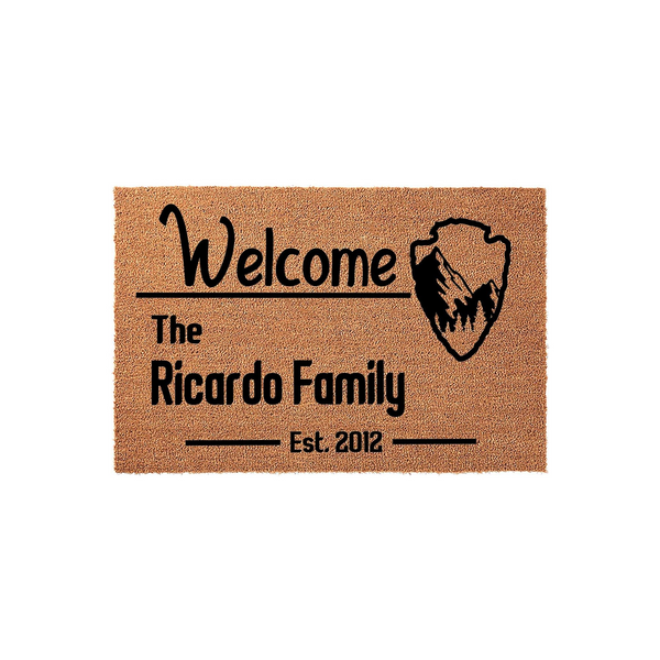 Personalized Family Name Welcome Doormat featuring a rustic mountain arrowhead graphic on a natural coir fiber mat, customized with a family name and established year to create a welcoming entrance for any home or front porch