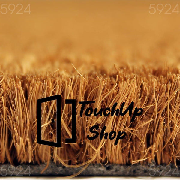 A close-up view of a textured surface, possibly a woven material or a natural plant fiber, with a warm, golden-brown color.