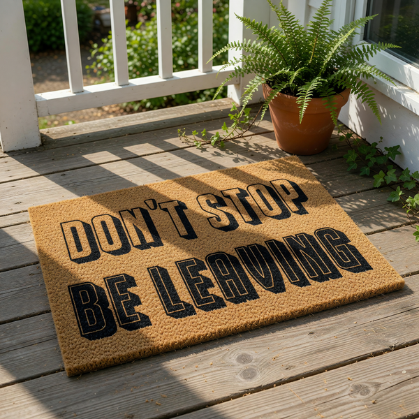 Funny doormat with the text Don't Stop Be Leaving printed in bold black letters on a natural coir fiber mat, creating a humorous welcome mat for your front porch or entryway that is sure to make guests laugh when they arrive at
