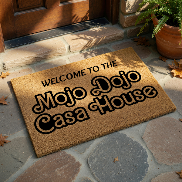 Mojo Dojo Casa House welcome doormat featuring bold, retro-style black typography printed on a natural tan coir fiber mat, creating a fun and trendy entryway accent for any home that loves pop culture references and unique decor.