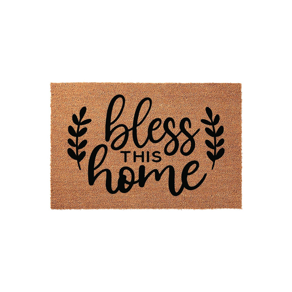 Bless This Home coir doormat featuring a natural tan fiber texture and bold black script lettering, accented by simple leaf sprigs on each side to create a welcoming farmhouse aesthetic for your front porch entryway decor.