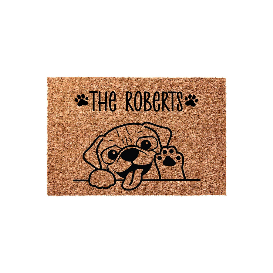Personalized Pug Dog Doormat featuring a cute illustrated puppy peeking over a line with a paw raised, set against a natural coir fiber background with space for a custom family name printed in bold black lettering above the dog