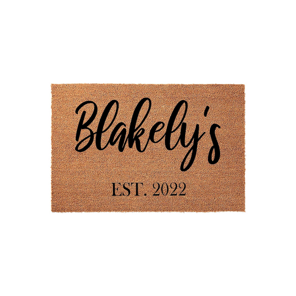 Personalized family name coir doormat featuring a natural tan fiber texture and black script lettering that displays a custom last name followed by the established year, creating a welcoming entrance for any modern home front