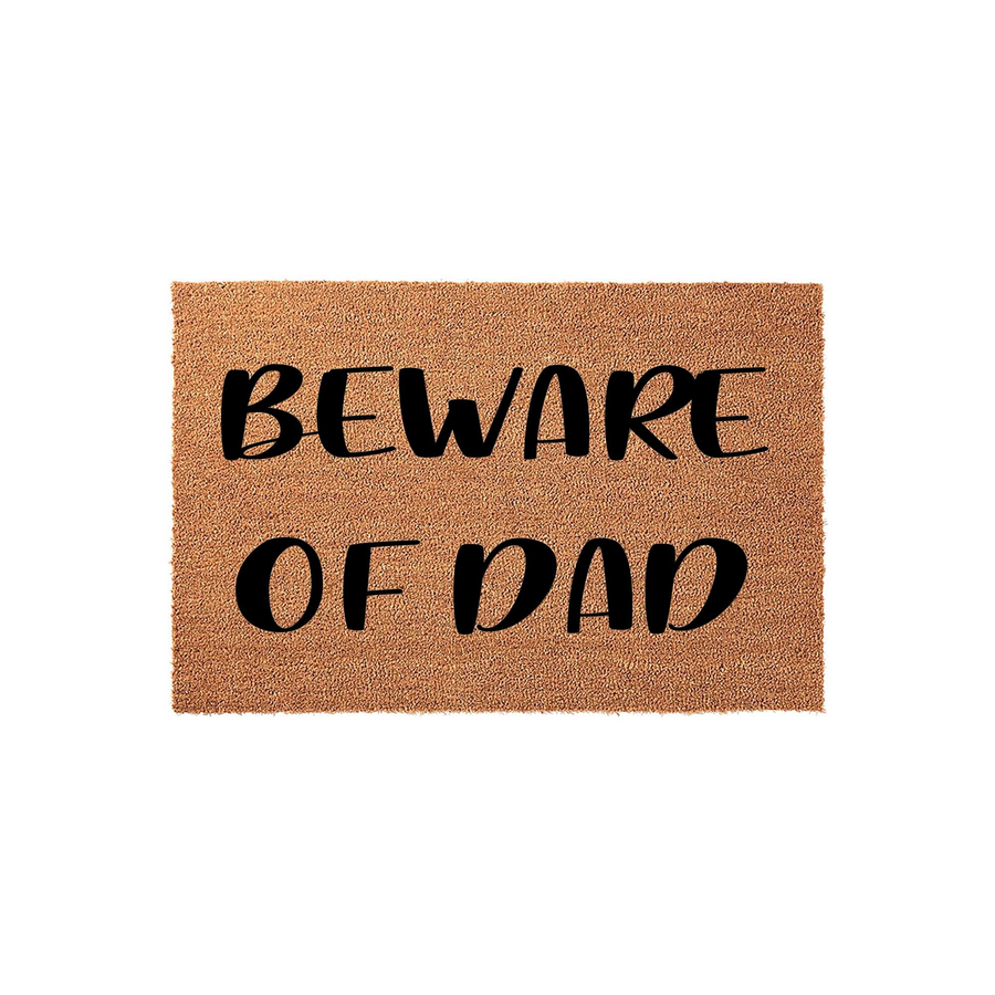 Beware of Dad coir doormat featuring a natural brown fiber texture and bold black lettering, serving as a humorous front porch welcome mat that adds a fun and personalized touch to any home entrance for a father figure.