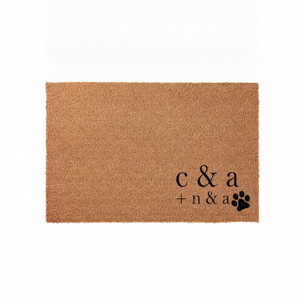 Personalized coir doormat featuring custom initials and a black paw print design, displayed on a clean white background to highlight the natural tan texture of the durable outdoor welcome mat for pet-loving families and new