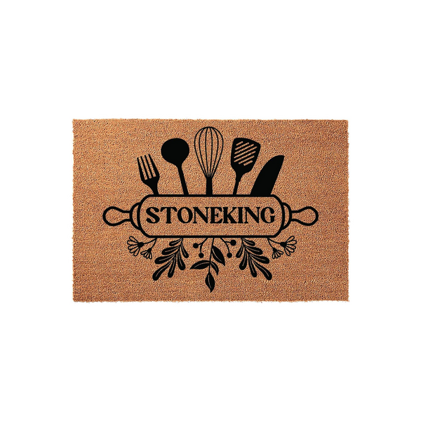 Personalized kitchen doormat featuring a black graphic of a rolling pin, whisk, and various cooking utensils over a natural coir background, with a custom family name printed in the center of the rolling pin design for a home
