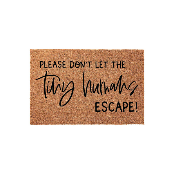 Funny Tiny Humans Escape doormat made of natural coir fiber with a textured brown surface, featuring bold black text that reads Please Don't Let The Tiny Humans Escape in a mix of modern sans-serif and elegant script fonts.