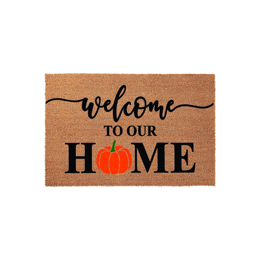 Fall Pumpkin Welcome To Our Home Doormat featuring a natural coir texture with black script and block lettering, where the letter O in the word home is replaced by a vibrant orange pumpkin illustration for a festive autumn porch