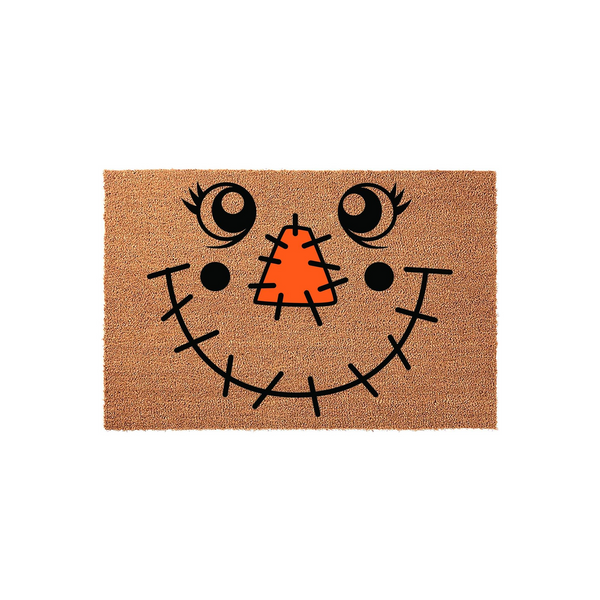 Scarecrow face coir doormat featuring a cheerful design with a bright orange stitched nose, large expressive eyes, and a wide stitched smile on a natural tan fiber background, perfect for adding festive fall decor to your front