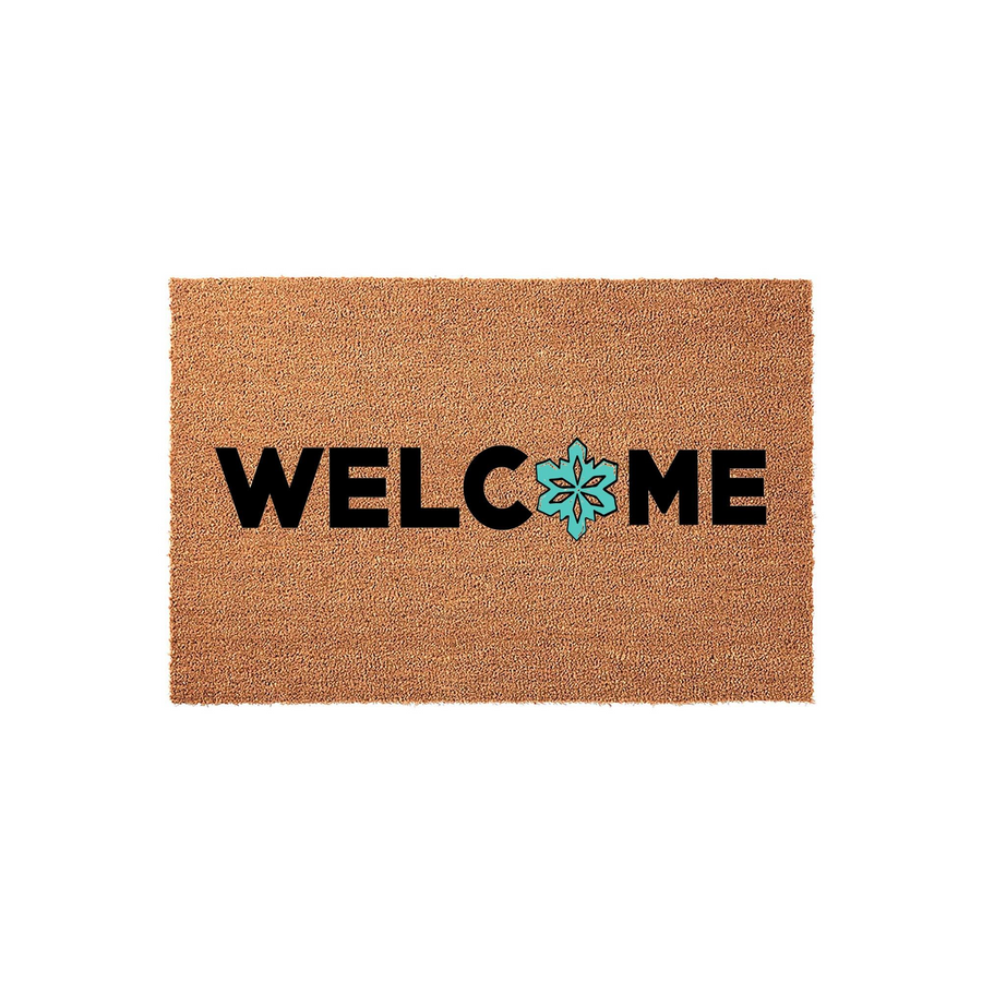 Welcome coir doormat with a rustic brown natural fiber texture, featuring bold black lettering and a bright turquoise snowflake icon replacing the letter O to create a festive winter entryway decor piece for your front porch.