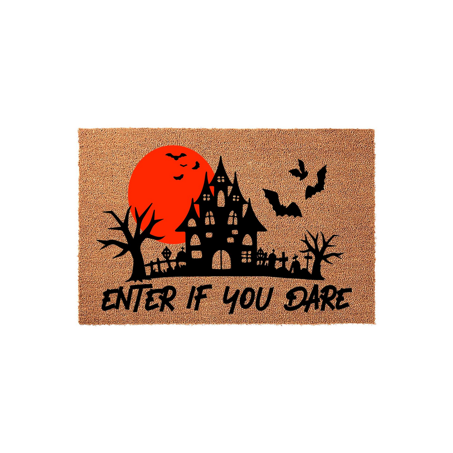 Halloween Haunted House Doormat featuring a spooky black silhouette of a mansion, bare trees, and bats against a large red moon, with the text Enter If You Dare printed in a jagged font on a natural coir fiber background for fall
