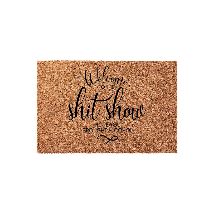 Funny Welcome to the Shit Show doormat made of natural coir fiber with a durable backing, featuring bold black typography that reads Welcome to the shit show hope you brought alcohol on a plain white studio background for your