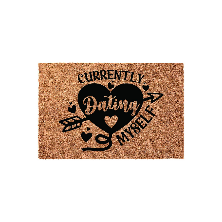 Currently Dating Myself coir doormat featuring a large black heart pierced by an arrow and decorative small hearts, set against a natural tan textured fiber background for a humorous and stylish entryway floor decor statement