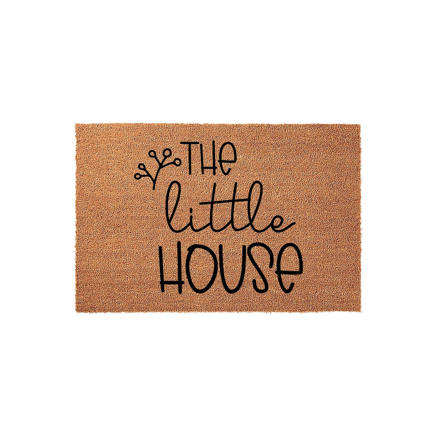 The Little House coir doormat features a natural tan fiber texture with black script lettering and a small botanical sprig design, creating a charming and welcoming entrance piece for any front porch or home entryway decor.