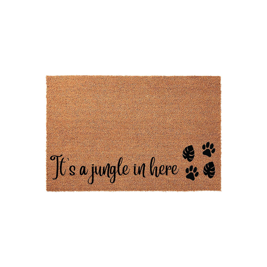 It's a jungle in here coir doormat featuring a natural brown fiber texture with black printed text and decorative paw prints and tropical monstera leaves, displayed against a clean white background for a modern entryway decor