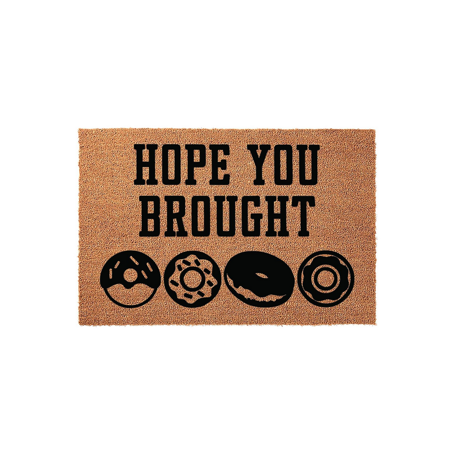Funny Donut Welcome Doormat featuring the text Hope You Brought Donuts in bold black lettering on a natural tan coir fiber background, complete with four distinct donut illustrations printed across the bottom of the rectangular