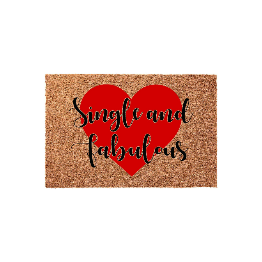 Single and Fabulous coir doormat featuring a large, bold red heart printed in the center of the natural brown fiber mat, with the text written in a stylish black cursive font against a clean, plain white studio background.