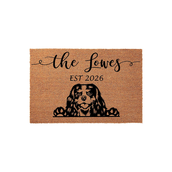 Personalized Cavalier King Charles Spaniel doormat featuring a cute dog peeking over the edge, customized with a family name and established year on a natural coir fiber background for a welcoming front porch entrance.