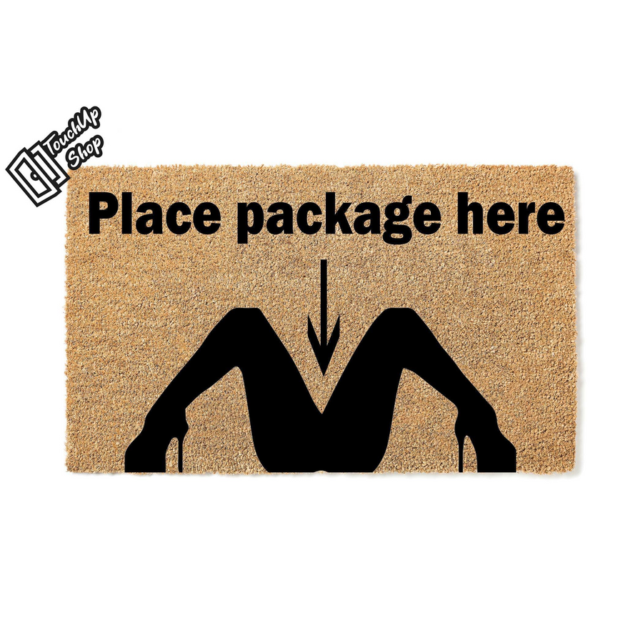 Funny Place Package Here doormat made of natural coir fiber, featuring a bold black silhouette graphic of legs in high heels with a downward pointing arrow to indicate where delivery drivers should leave your incoming packages.