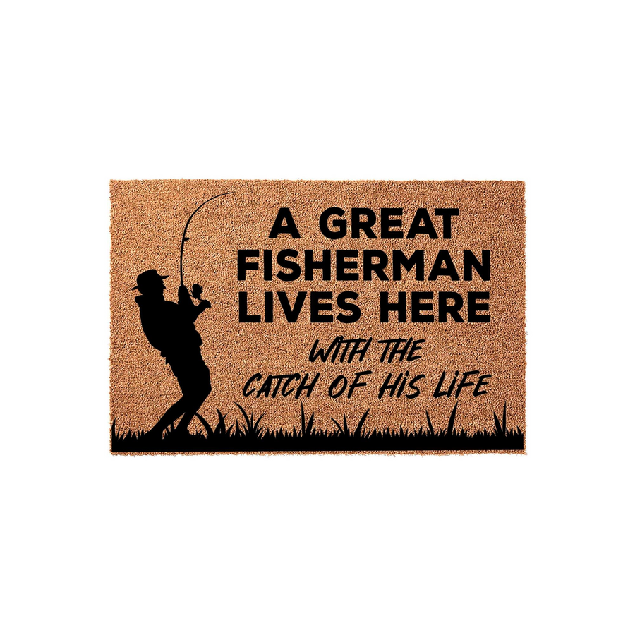 Fisherman Coir Doormat featuring a silhouette of a person fishing with the text A Great Fisherman Lives Here With The Catch Of His Life printed in black on a natural tan textured fiber background for a rustic outdoor entryway
