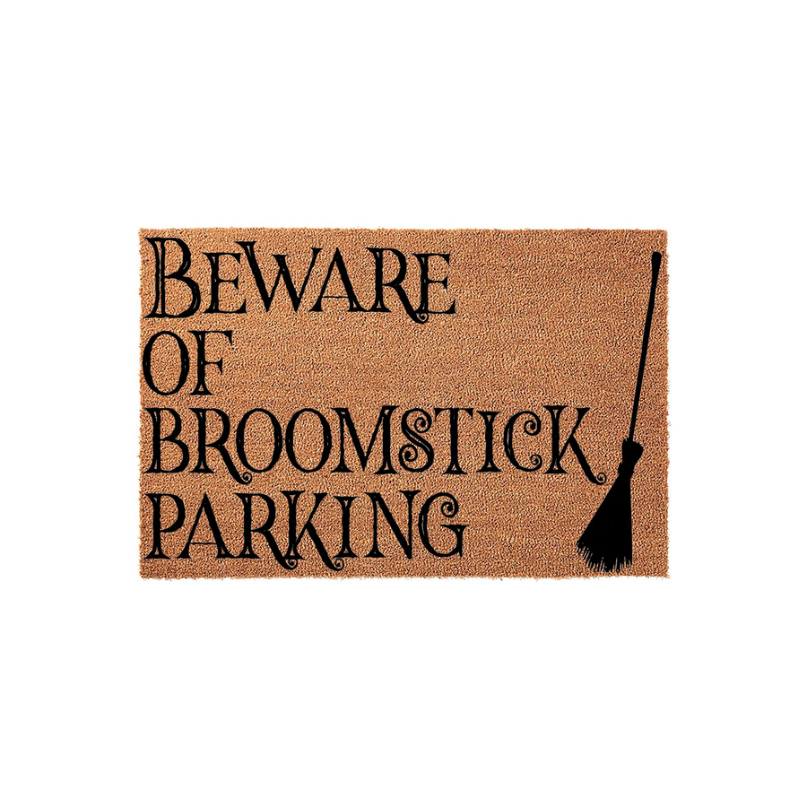 Beware of Broomstick Parking Halloween doormat featuring a natural coir texture and black decorative lettering, complete with a witch broomstick graphic on the right side for a fun and spooky seasonal front porch entryway decor.