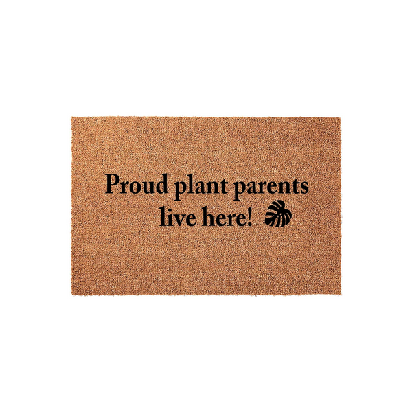 Proud plant parents live here coir doormat featuring a natural brown fiber texture and bold black text with a monstera leaf icon, perfect for a housewarming entrance decor update for any indoor or outdoor home entryway space.