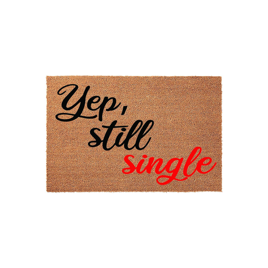 Funny Yep Still Single coir doormat featuring bold black and red cursive typography on a natural tan fiber background, making a humorous statement for a front porch entrance or apartment door decor that greets guests with