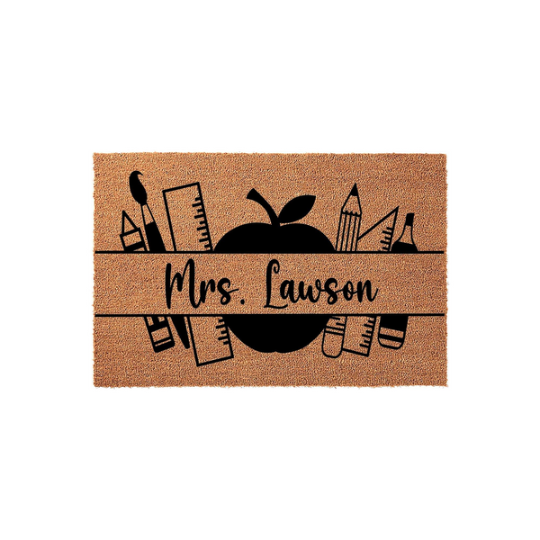 Personalized Teacher Coir Doormat featuring a black apple graphic and school supply icons like rulers and pencils, with a custom name space centered on a natural tan fiber background for a classroom or home entrance decor.