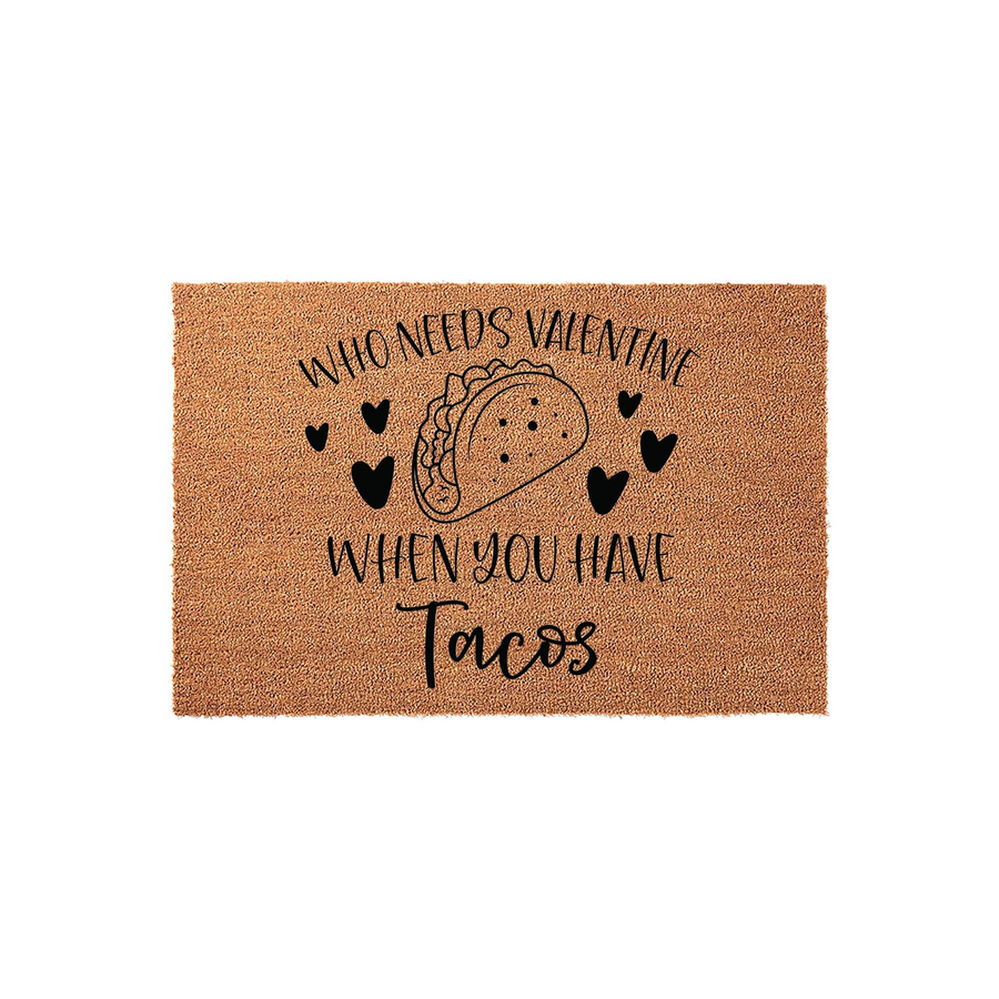 Funny Taco Valentine Doormat featuring a natural coir texture with black printed text that reads Who Needs Valentine When You Have Tacos, accented by a central taco illustration and small hearts on a clean white studio background.