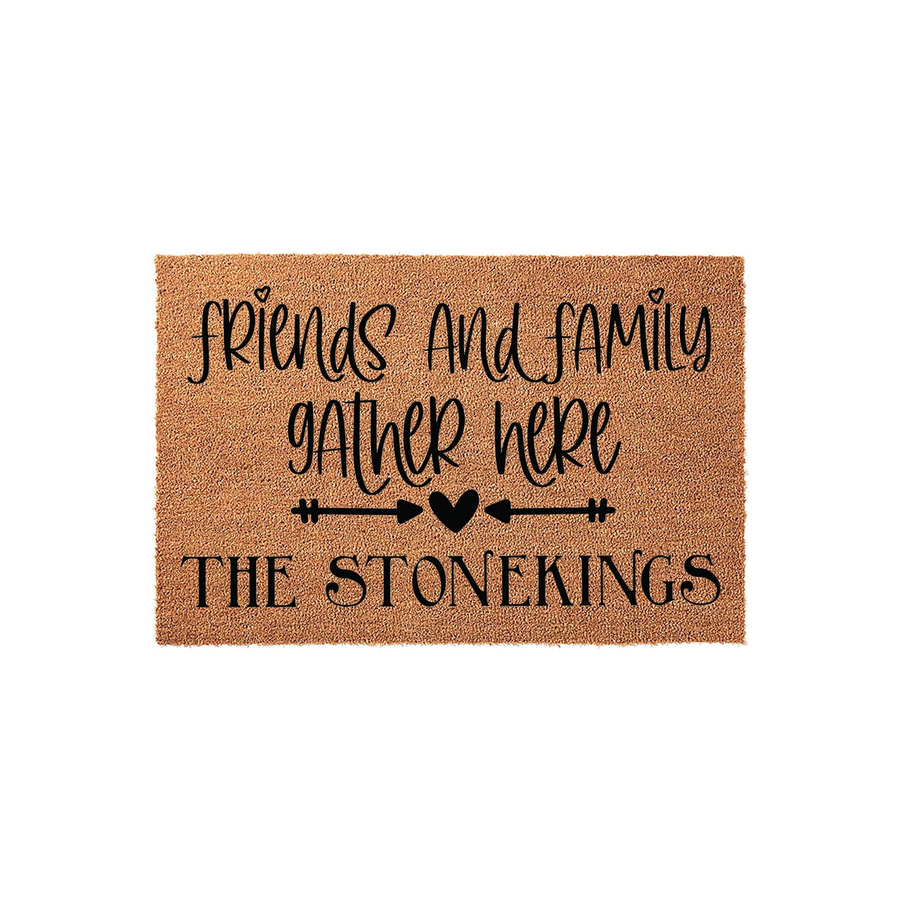 Personalized Friends and Family Gather Here doormat featuring a natural coir texture with black script lettering, a decorative arrow and heart icon, and a customizable family name printed on a clean white studio background.