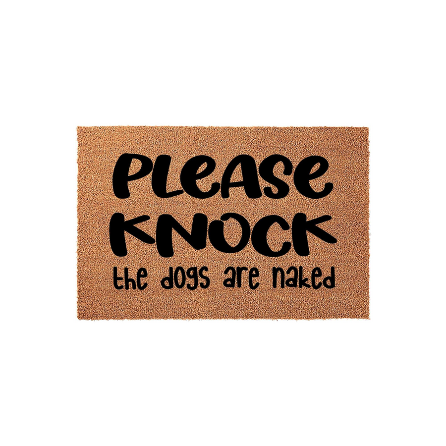 Funny Dog Welcome Doormat featuring a natural coir texture with bold black lettering that reads Please Knock the dogs are naked, making this a humorous and functional entryway rug for any pet lover's home front porch or door