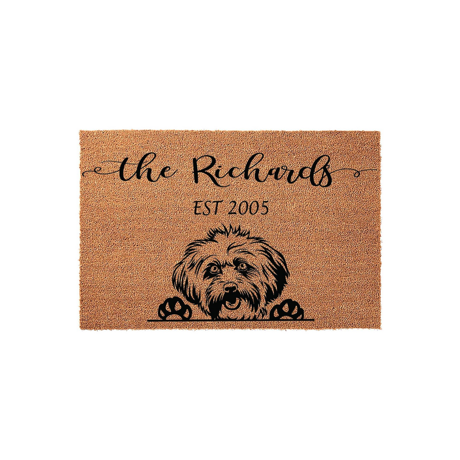 Personalized Havanese dog doormat featuring a natural coir texture with a black illustration of a Havanese puppy peeking over the edge, customized with a family name and established year for a welcoming front porch entrance decor.