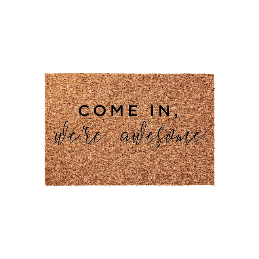 Funny Welcome Doormat featuring a natural coir fiber texture and bold black text that reads Come In, we're awesome, making this a humorous and inviting front porch decor piece for any home entrance or apartment doorway.
