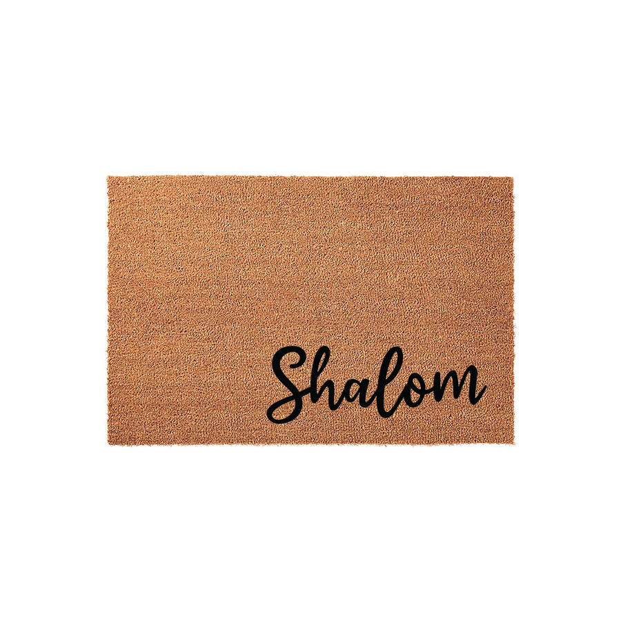 Shalom coir doormat featuring a natural brown fiber texture and elegant black script lettering, providing a warm and inviting welcome for your front porch entrance while keeping your home clean with its durable, rustic outdoor