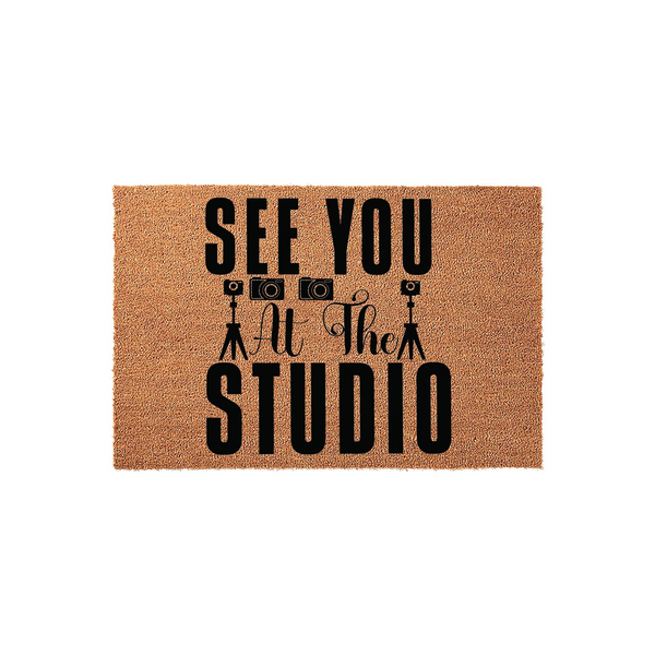 Photography Studio Coir Doormat featuring the text See You At The Studio in bold black lettering, accented by small camera and tripod icons on a natural brown textured coir fiber background for a professional photography business